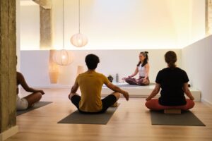 A,Group,Of,People,Are,Sitting,On,Yoga,Mats,Meditating
